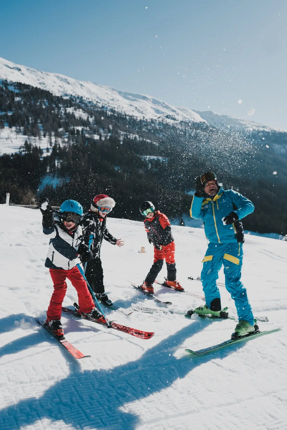 Skilehrer und Kinder haben Spaß im Schnee