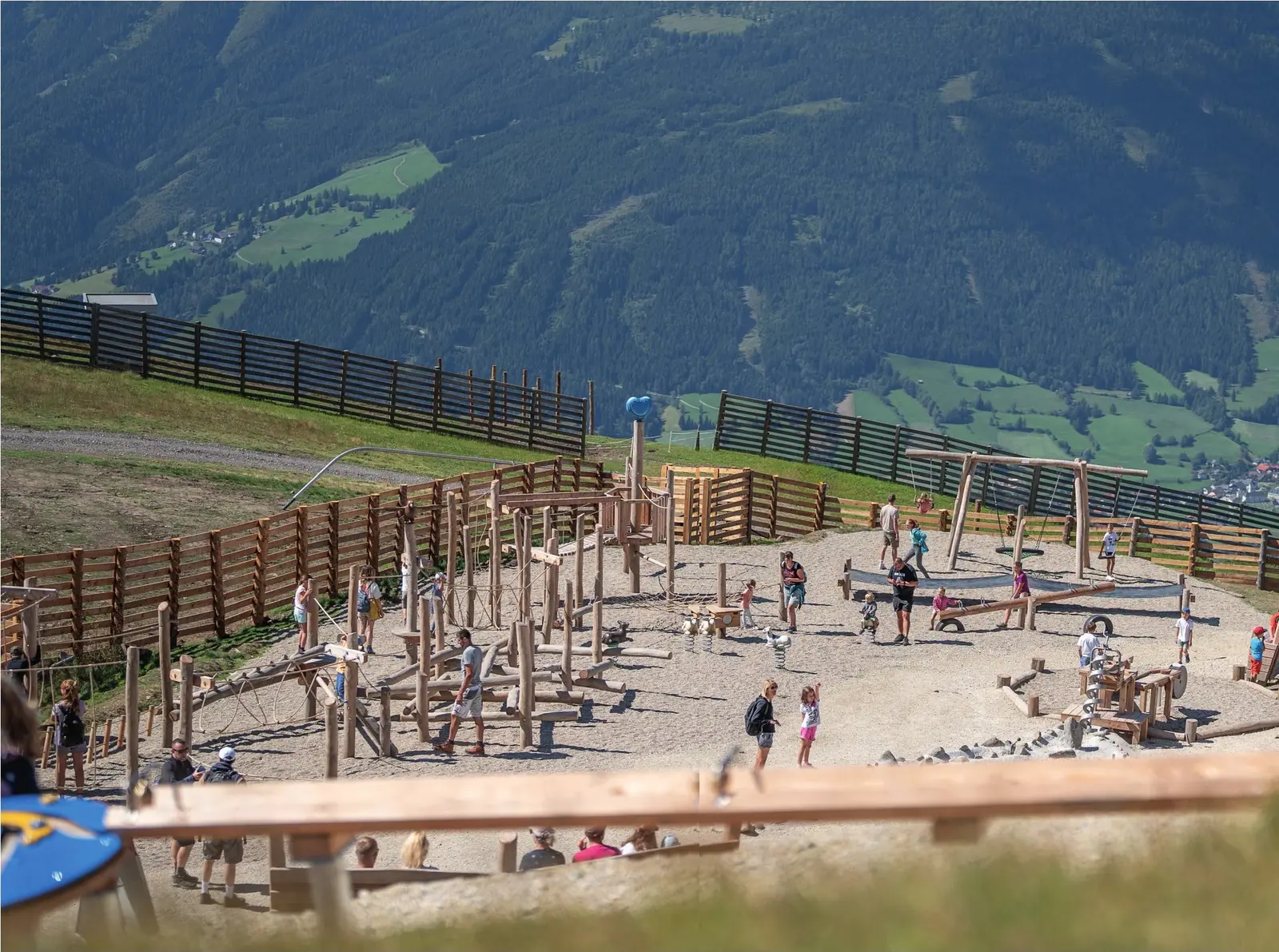Familien auf dem Almspielplatz am Aineck mit Blick ins Tal